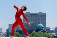 A dancer practicies Brown’s Roof Piece against the Philadelphia skyline.